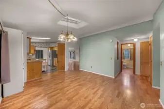 Great room looking into kitchen and hallway bathroom