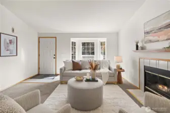 Lovely living room with gas fireplace and bay window