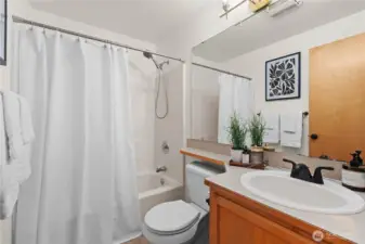 Hall bath with bathtub and shower!  New light fixtures and faucet.  Enjoy new floors in here too!