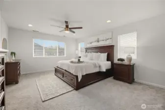 Large primary bedroom features French door entry