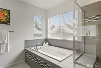 Huge ensuite 5-piece bathroom with builder upgraded tile countertops and tile flooring