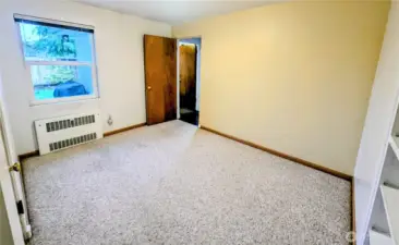 The third bedroom has two doors, either to the kitchen or to the hallway.