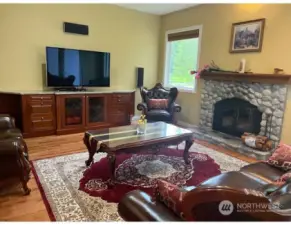 Family Room with River Rock Fire Place, built in cupboards with built in speakers and marble Counter top