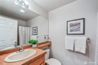 The main bath is just across the hall from the den/guest room.