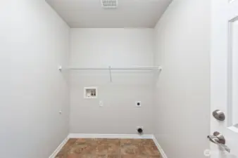 The laundry room has plenty of space for a full sized washer & dryer.