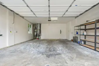 Two car garage with some storage area.