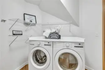 The convenient laundry space just off the garage offers both practicality and ease of access. Featuring a brand-new washer and dryer.