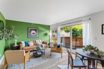 Light filled living room with glass slider to private patio