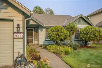 Well-maintained mature landscaping with front and rear sprinkler system