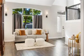 Entry is to the right of this photo, which then takes you either to the office, half bath, utility & garage, or you can circle into the kitchen on the other side of the stairs. Behind this photo is the dining room and a 2nd entrance to the kitchen. The layout of this home is fantastic.
