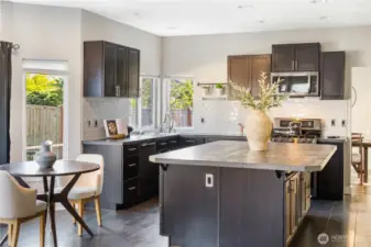 Light & Bright kitchen with eating nook. Slider opens to the backyard to the left. To the right move toward the front entry or the main level office. Behind is the Family Room