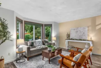The formal living room boasts large windows with serene front yard views, engineered hardwoods & sand swirl ceiling texture.