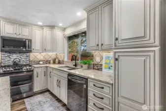 Abundant custom cabinetry with biscottie glaze. Soft close drawers & cabinets, pull-out shelves & more!
