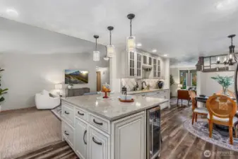 Look closely to find a pop-up charging station with outlets in the center of the quartz peninsula! Love the storage options and beautiful detail in this space!