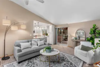 The family room is open to entry & kitchen & offers access to the screened sunroom through a sliding glass door.