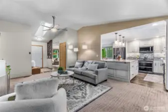 This angle shows easy flow from the family room to kitchen, dining, living & entry. A hallway on the left leads to bedrooms & bathrooms.