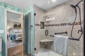 Love the fablulous full tile walk-in shower with floor to ceiling tile & gleaming glass doors! A storage closet to the left of the shower offers space for towels, toiletries & supplies.