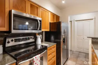 Gorgeous slab counters & handsome wood cabinets.