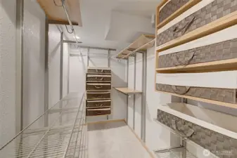 Owner's suite custom closet with baskets