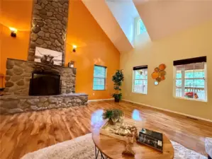 Back in the great room, the river-rock wood fireplace is dramatically beautiful!