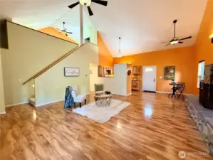 Another view of the greenroom, dining area and stairs leading to the loft styled Primary bedroom ensuite.