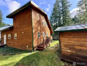 Front-side of the home, with an outbuilding uses for storage.