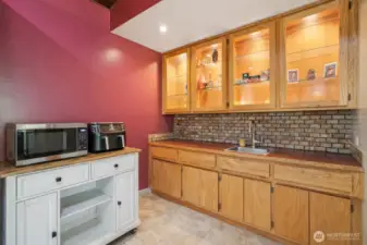 Kitchen with ample cabinetry and workspace, and a wet bar
