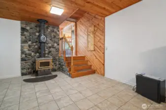 Bonus space, part of the mudroom, leading to the main living area. Cozy fireplace