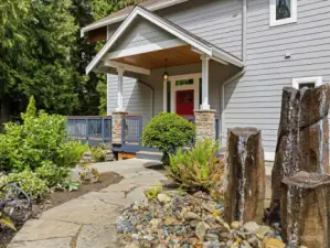 Lovingly landscaped with a stone walkway to the front door and water feature.
