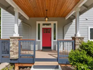 Covered front porch & entry leads into a wrap-around deck perfect for entertaining.