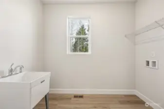 Laundry with sink, linen closet and window.