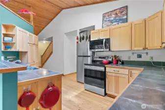 Hickory cabinetry and tile countertops blend warmth and function.