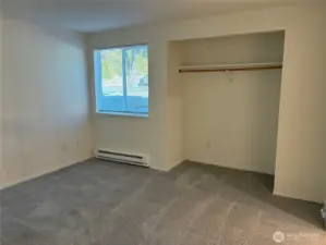 Spacious bedroom with open alcove/closet space.