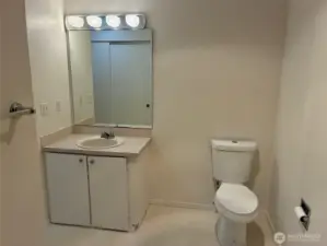 Large bathroom with walk in shower, second closet and storage shelves.