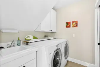 The main-level laundry room keeps things easy when everyone returns from the beach covered in sand. Half bath out of view, to the right.