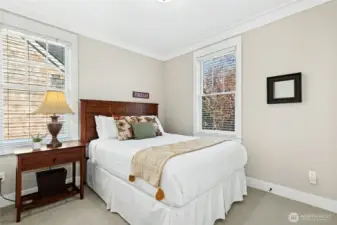 The second-floor guest room includes a comfortable queen bed and enjoys easy access to a full bath just across the hall.