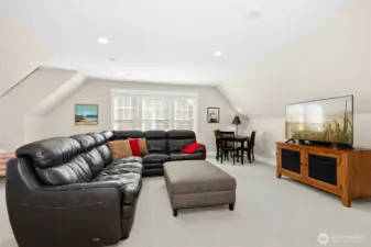 The third-floor loft offers a cozy spot to play, unwind, or watch a movie. Don't forget the popcorn!