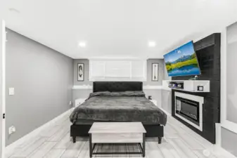 Picture of lower level rec/family room currently being used as a 4th bedroom. This beautiful fireplace has an electrical insert which can be converted easily into a wood burning fireplace as well.