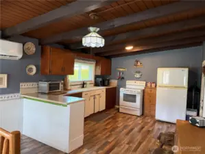 Note the warm wood beamed ceiling. All appliances included.