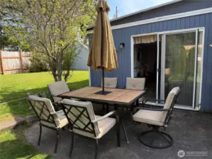 Patio with backyard and sliding door to bonus room.