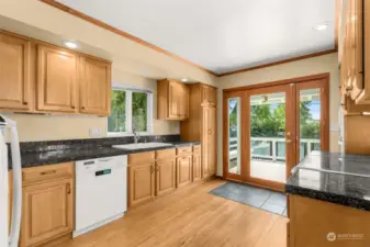 Updated kitchen with French doors leading to deck & backyard