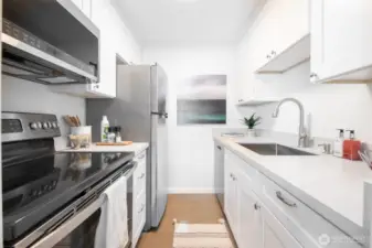 Completely remodeled bath with quartz counters and stainless steel appliances.