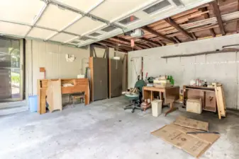 Garage with entry door to small shop