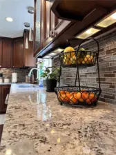 Beautiful high end cabinetry, countertops, backsplash, lighting and fixtures in the chef's kitchen.