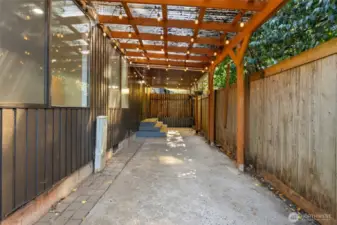 Covered back patio area with stringlights
