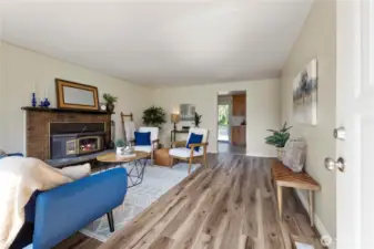 Enter into the large living space that was just upgraded with stylish laminate flooring