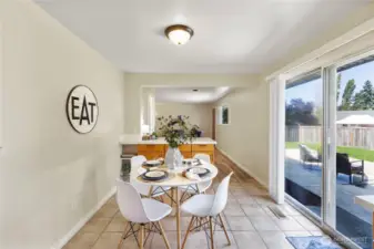 From the kitchen you can step out the rear slider to the huge backyard patio-  or head through kitchen into the Family room.