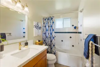 This main bath just got an ugrade with a new vanity, countertop, sink & fawcett.  Enjoy the jetted tub with a tile surround.