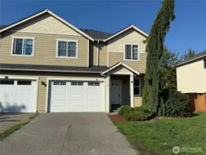 Duplex style townhome with spacious driveway and oversized one car garage