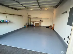 Rustoleum floor coating is attractive and much easier to clean than bare cement!   Workbench and extra shelving